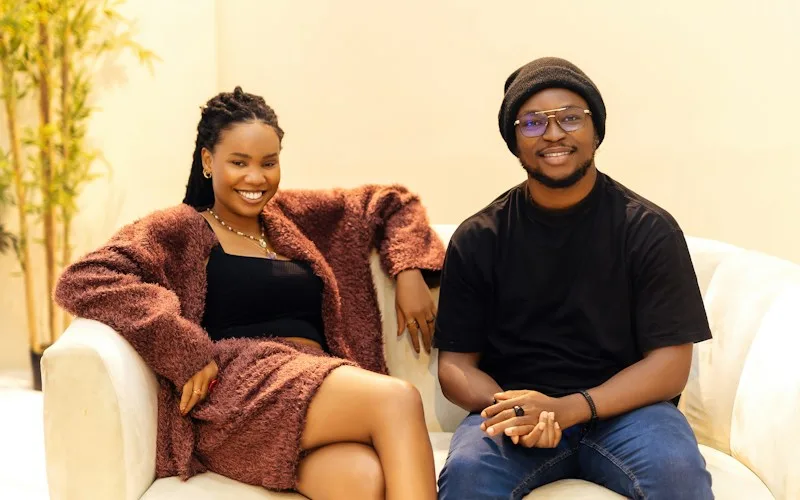 Relaxed couple smiling together on a sofa, reflecting open conversation and confidence with premature ejaculation support